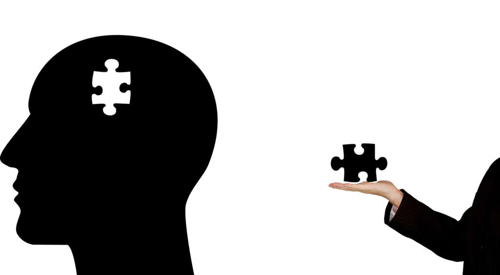 Silhouette of a human head with a puzzle piece missing, symbolizing the complexities and challenges of mental health.