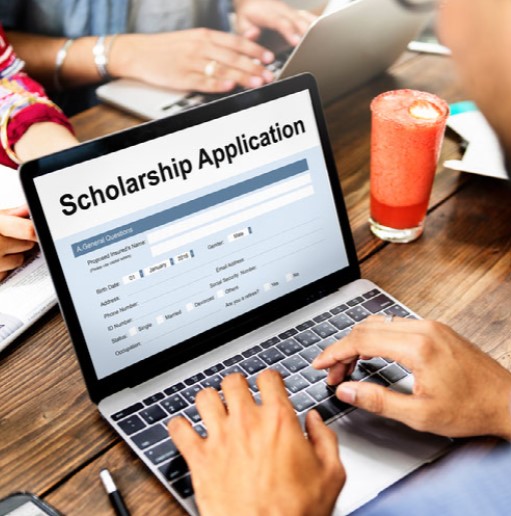Image of person searching for a scholarship application on a laptop