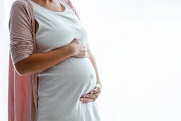 Pregnant woman holding her stomach