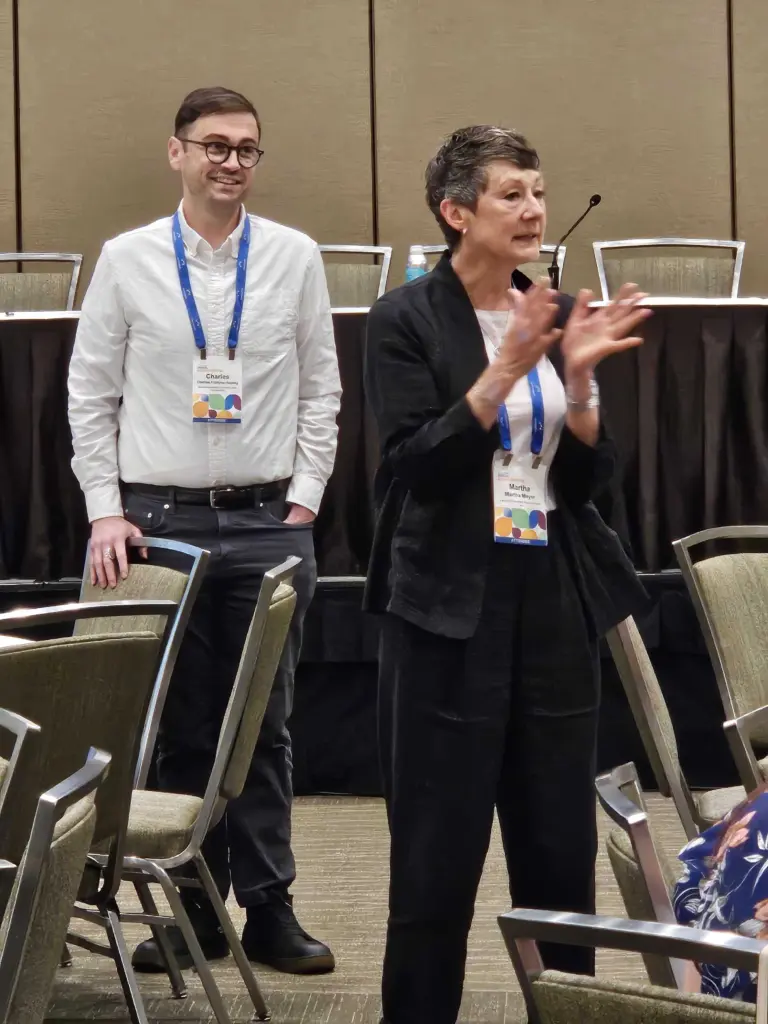 Martha Meyer stands in front of a group of people at the 2026 AcademyHealth Research Meeting.