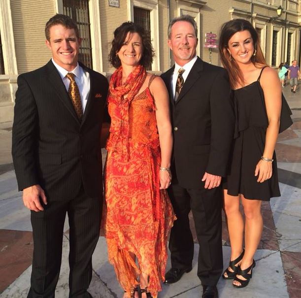 Ana English posing with her family in an outdoor setting. The group is smiling warmly, dressed in casual attire, with a natural background that reflects a joyful and relaxed atmosphere.